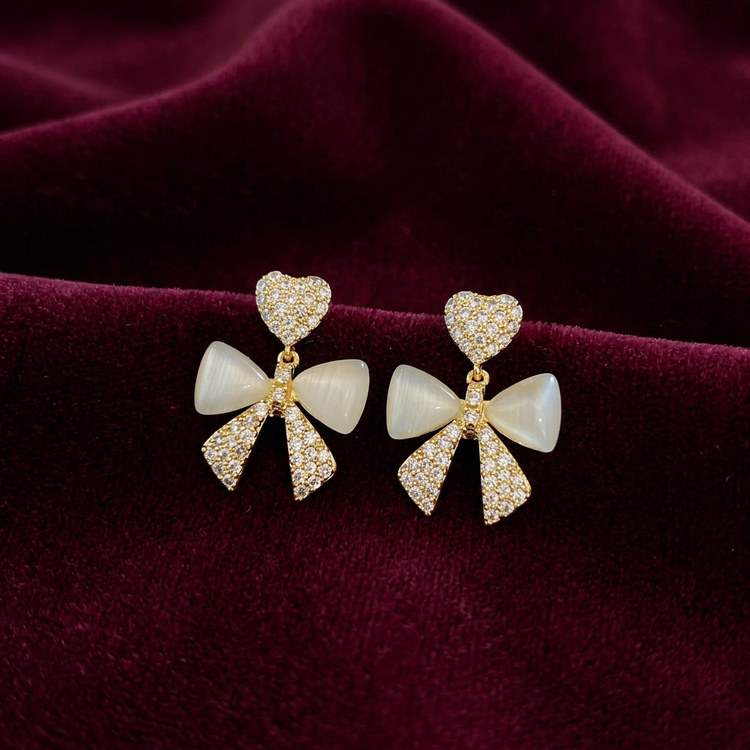 Heart and bow earrings on deep burgundy velvet